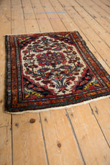 Vintage Dargezine rug corner showcasing madder red, navy, ivory floral motifs, and boteh border.