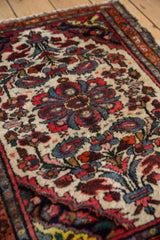 Ivory field of a Persian Dargezine rug with inwardly directed floral bouquets and boteh.