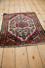 Corner detail of vintage Persian Dargezine rug, with ivory floral motifs, boteh border, and fringe.