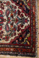 Corner of the vintage Dargezine rug, highlighting ivory floral field, boteh border, and fringe.