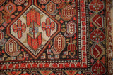 Malayer runner detail: cherry red diamond medallion, powder blue botehs, floral pomegranate border.