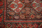 Detail of Vintage Malayer runner with cherry red pomegranate main border and geometric guard.
