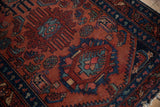 Vintage Lilihan runner with intricate curvilinear design motifs in raspberry red, sapphire, and emerald.