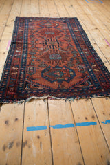 Vintage Lilihan runner end with tattered fringe and patterned border in red and blue.