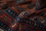 Hand-knotted Lilihan rug's textured pile, showcasing varied ruby red and sapphire blue patterns.