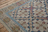 Distressed Turkish Soumac rug with ivory, blue, and raspberry floral medallions.