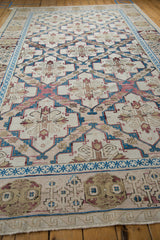 Distressed Turkish Soumac rug: blue geometric border, ivory, raspberry floral medallions, and selvage.
