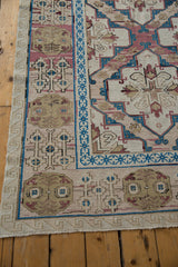 Secured fringe and geometric borders of an ivory, blue, and blush Distressed Turkish Soumac carpet.