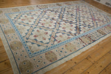 Distressed Turkish Soumac rug corner showing sapphire blue border and blush-toned abrashes.