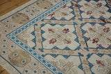 Distressed Turkish Soumac rug detail: sapphire blue geometric border, blush field, ivory quatrefoil.
