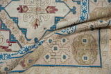 Distressed Soumac carpet detail revealing heavy abrashes, sapphire blue, ivory, and raspberry motifs.