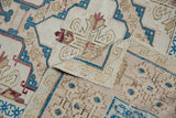 Distressed Turkish Soumac rug close-up with sapphire blue, blush geometric motifs and abrashes.