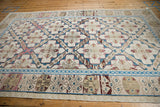 Geometric sapphire and raspberry borders with ivory Greek key on distressed Soumac carpet.