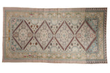 Vintage Distressed Turkish Soumac carpet with central pomegranate medallions, germinating plant borders, pastel palette.
