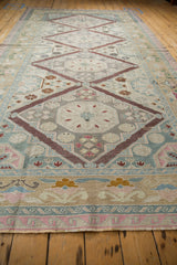 Pink reciprocating wave design border and fringed end of the vintage Soumac rug.