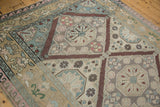 Intricate Soumac medallion with pomegranate motif in soft pink, blue, and neutral shades.