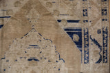 Distressed Oushak rug: corner spandrel abrashes, cobalt blue serrated leaf, lotus flower border.
