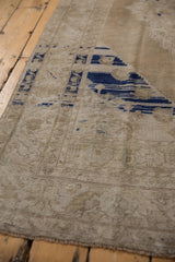 Distressed vintage Oushak rug with prominent cobalt blue abrash and faded border patterns.