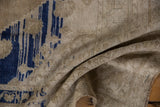 Distressed vintage Oushak rug texture featuring cobalt blue and soft beige tones.