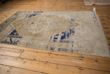 Vintage Oushak rug's distressed cobalt blue and sand serrated leaf border.