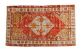 Vintage Distressed Oushak rug, pomegranate red field, saffron yellow medallion.