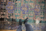 Heavily distressed vintage Oushak runner displaying violet-purple and dusty teal hues with visible foundation texture.