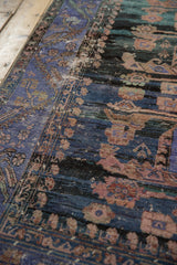 Worn pile and Herati-inspired motifs in violet, copper, and teal on vintage Oushak rug.