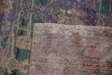 Distressed Oushak rug pile texture in dusty teal, violet, copper, with visible foundation and fringe.