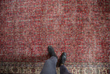 Distressed vintage Sparta rug in cherry red, allover vinery, faded texture, and border.