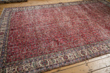 Distressed cherry red vintage Sparta carpet, allover vinery pattern and light floral borders.