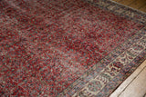 Distressed cherry red field with delicate patterns, transitioning to an ivory floral border.