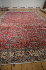 Distressed Sparta carpet border with beige field, red, blue floral motifs, and fringe.