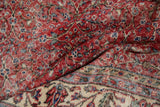 Distressed cherry red vintage Sparta carpet with scrolling vinery and ivory border detail.