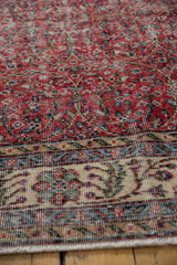 Distressed vintage Sparta carpet texture with cherry red field and patterned ivory border.