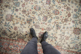 Distressed Sparta carpet underfoot, revealing ivory ground, pink and blue lotus flowers, and visible wear.