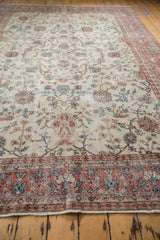Distressed texture and pink, blue, ivory floral vinery on vintage Sparta rug border.