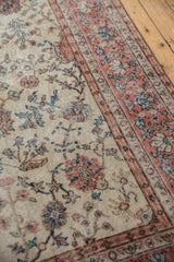 Distressed vintage Sparta carpet: ivory field with faded pink border, blue palmettes and vinery.