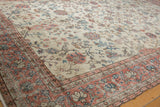 Distressed vintage Sparta rug corner showing mostly even wear to knot heads and floral borders.