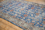 Vintage distressed Sparta carpet corner: blue field, terracotta motifs, ivory border, worn pile.