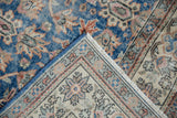 Folded Sparta carpet showing distressed blue field with terracotta patterns and intricate reverse.