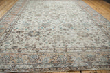 Distressed ivory ground with faded lotus flowers and vinery motifs on this Sparta rug.