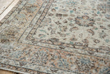 Distressed vintage Sparta carpet corner showing faded ivory, apricot, celadon green florals.