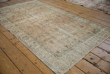 Faded allover spiral vine pattern on a distressed vintage Turkish Sparta rug.