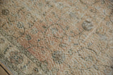 Distressed Turkish Sparta rug: worn pile texture, pale floral vines, ivory border.