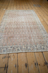 Distressed Turkish Sparta rug with faded melon, ivory, navy germinating flowers pattern.