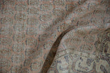 Vintage distressed Sparta rug with faded cantaloupe pile and exposed foundation.