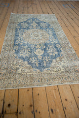 Distressed Sparta runner border with ivory, blue, and apricot vine and lotus motifs.