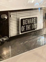 Monochrome photograph of a door with deadbolt, blinds, and a Beware of the Dog sign, 10x15.