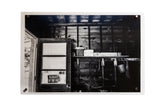 His Garage, a black and white photo showing a rustic shed interior with a wood-paneled door.