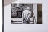 The Walk, a framed black and white photograph of a man in a suit and hat against a graffiti wall.